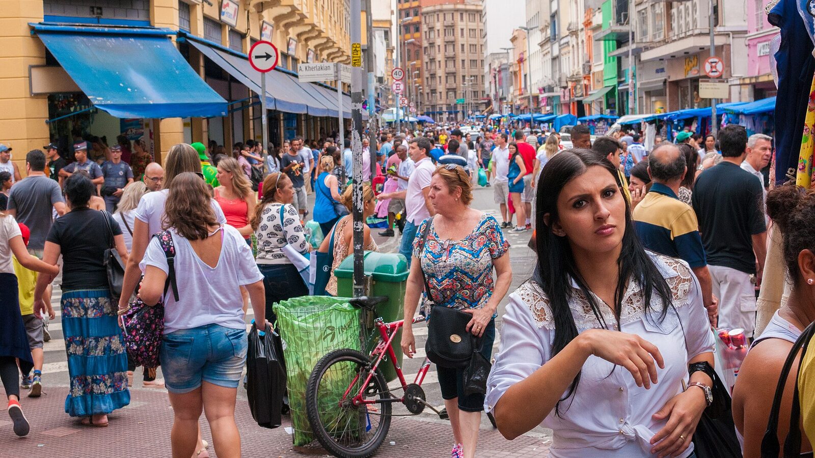 A shopping street of the centre crowded with buyers, near the Mercado Municipal. São Paulo, Brazil