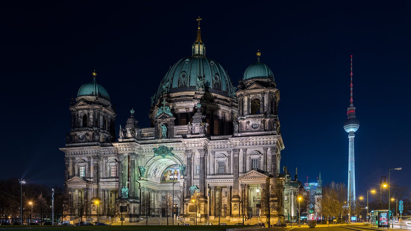 Berlin cathedral at night as seen from west. On the right in the background the Fernsehturm (tv tower) can be seen