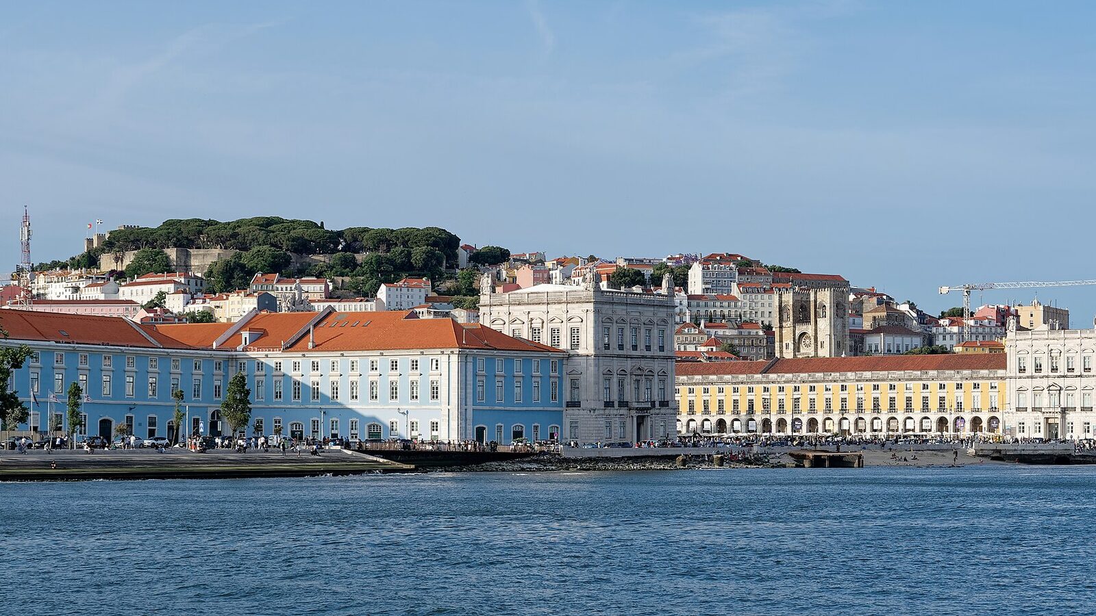 View of Praça do Comércio and Doca da Caldeirinha from the Tagus River in Lisbon, with Castelo de São Jorge in the background