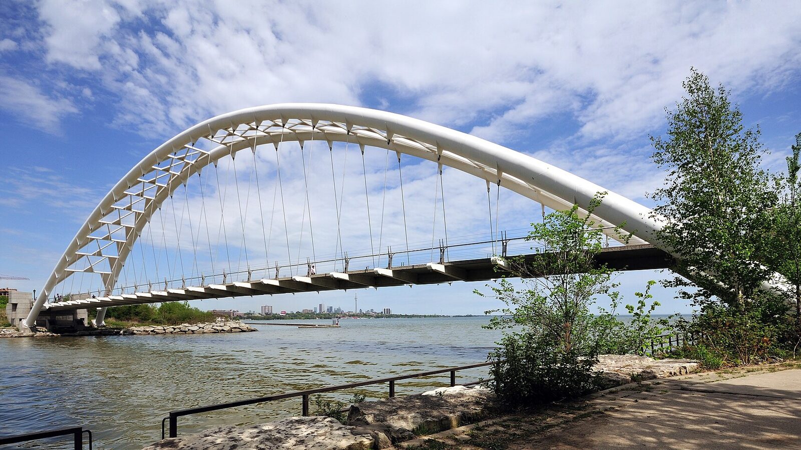 Humber Bay Arch Bridge and Humber Bay, in background Toronto Skyline is visible