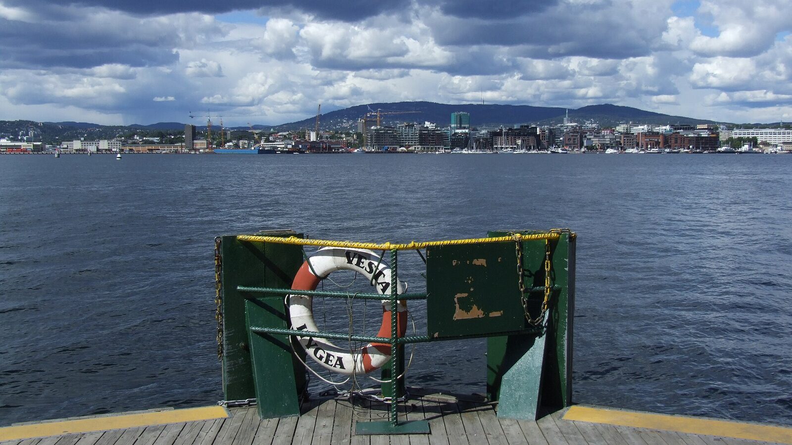 Harbour in Hovedøya island, Oslo. In the background city center of capital