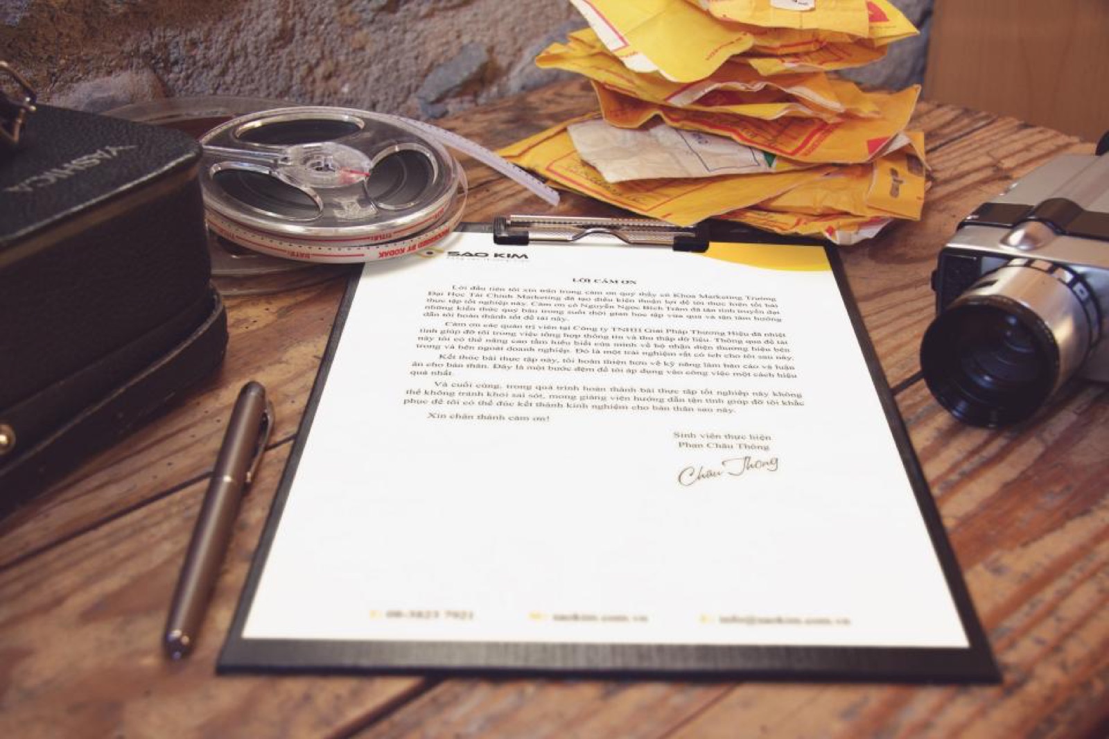Application documents and a pen on a desk