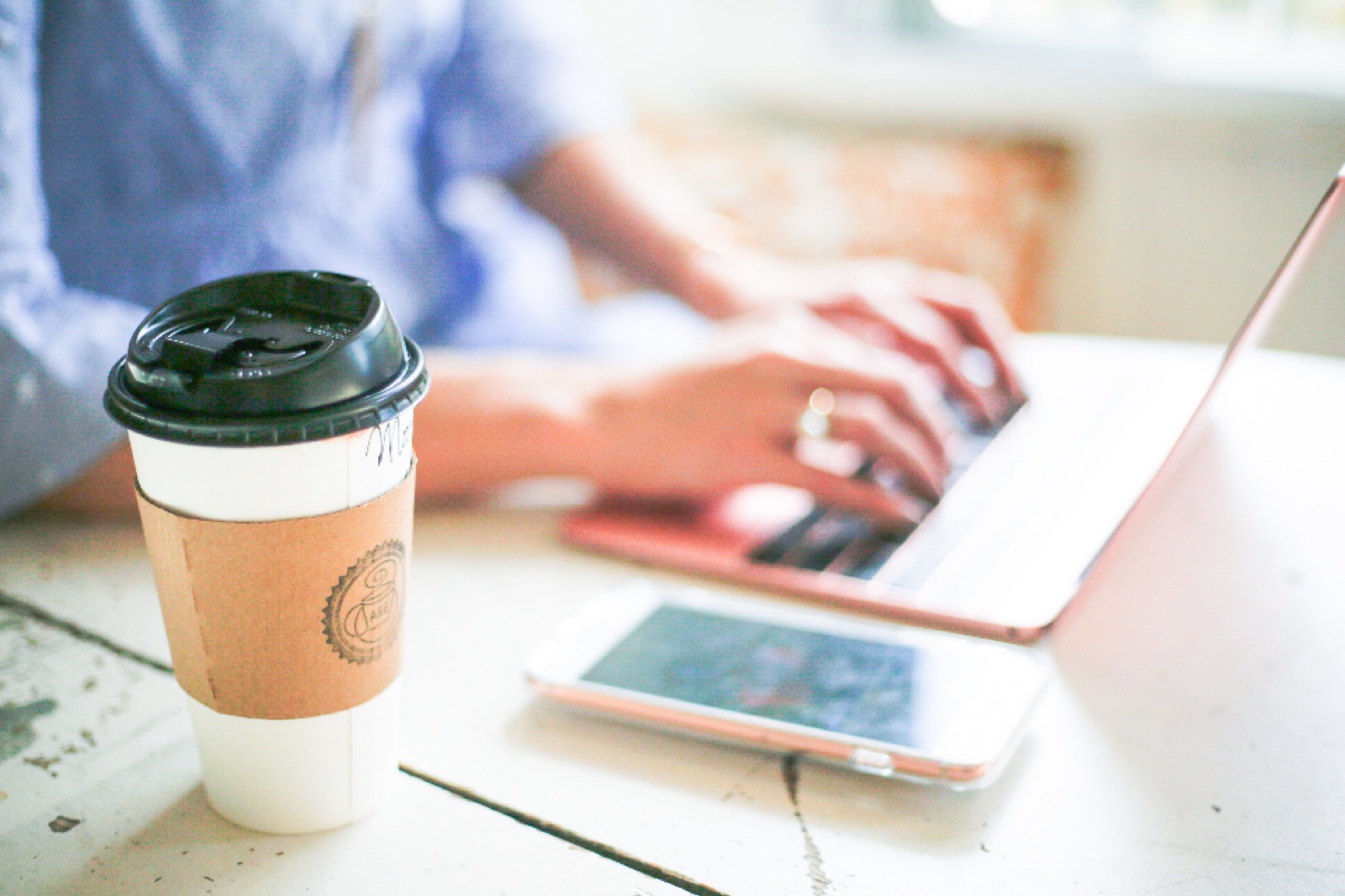 Working remotely on a laptop with coffee